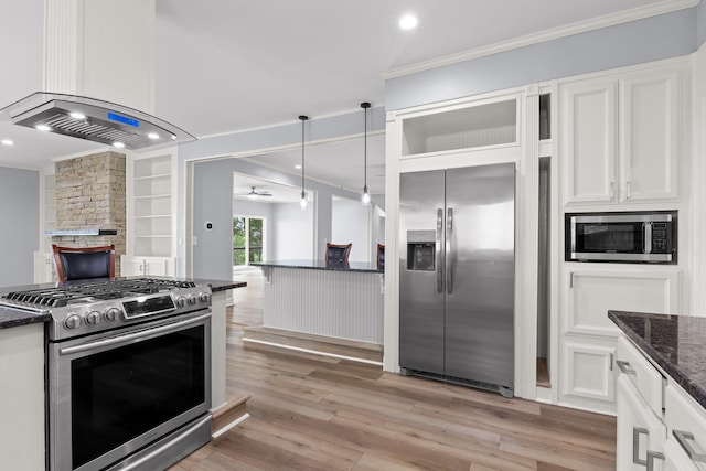 1206 Lower Brow Rd, Signal Mountain, TN 37377 - kitchen featuring stainless steel appliances, wall chimney range hood, ornamental molding, dark stone countertops, and white cabinets