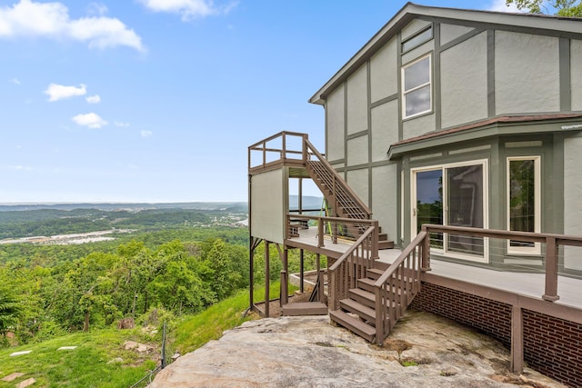 1206 Lower Brow Rd, Signal Mountain, TN 37377 - view of property exterior featuring stairway, a deck, stucco siding, and a forest view
