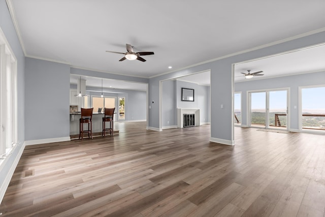1206 Lower Brow Rd, Signal Mountain, TN 37377 - unfurnished living room with a ceiling fan, wood finished floors, plenty of natural light, baseboards, and crown molding