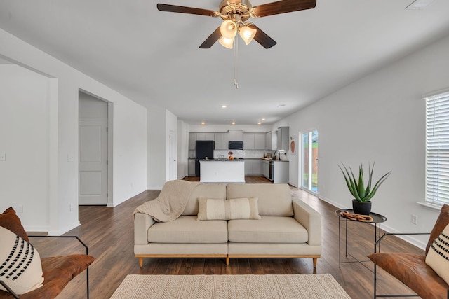 living area featuring a ceiling fan, baseboards, recessed lighting, and wood finished floors