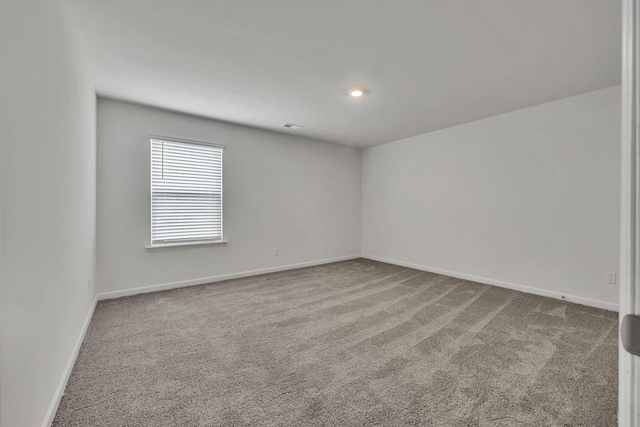 spare room with carpet floors and baseboards