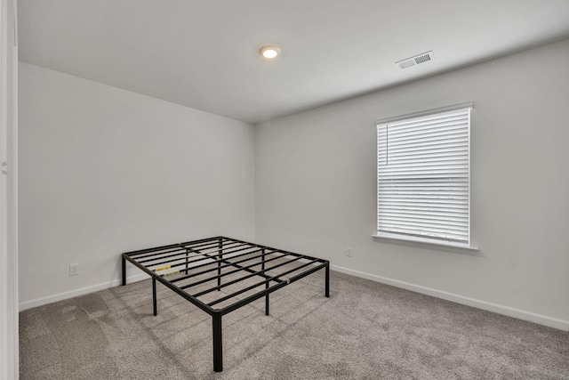 recreation room featuring baseboards, carpet floors, and visible vents