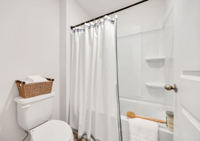 full bathroom featuring toilet and curtained shower