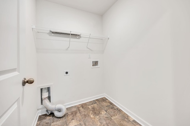 clothes washing area featuring laundry area, baseboards, stone finish flooring, electric dryer hookup, and washer hookup