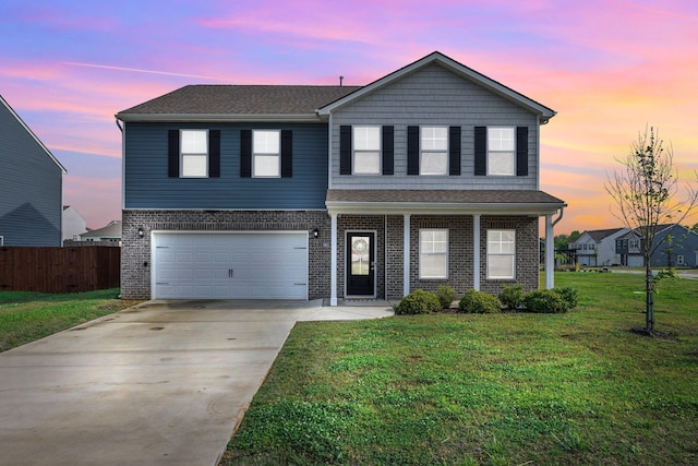 traditional home with driveway, a garage, brick siding, fence, and a yard