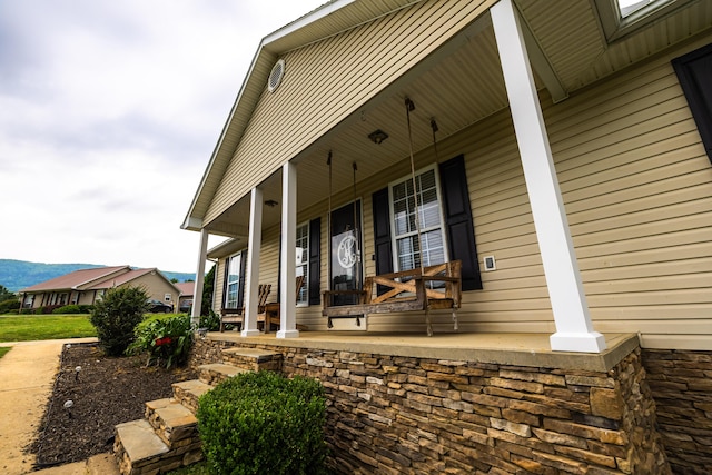 exterior space with covered porch and a mountain view