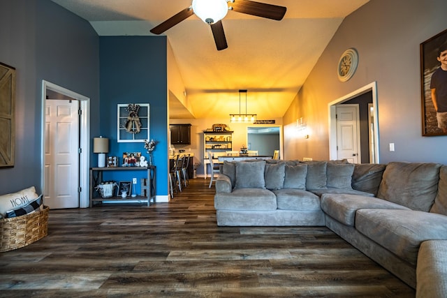 living area featuring a ceiling fan, high vaulted ceiling, and dark wood-type flooring