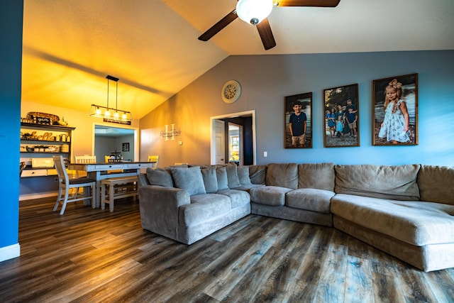 living room with ceiling fan, vaulted ceiling, and dark wood-type flooring