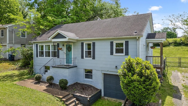 3610 Gleason Dr, Chattanooga, TN 37412 - ranch-style house with fence, an attached garage, a shingled roof, and a front yard