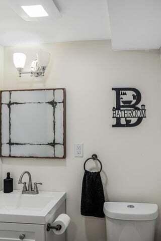 bathroom featuring vanity and toilet