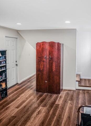 interior space featuring baseboards, recessed lighting, and wood finished floors