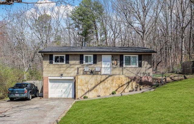 single story home featuring a garage, fence, a front lawn, and aphalt driveway