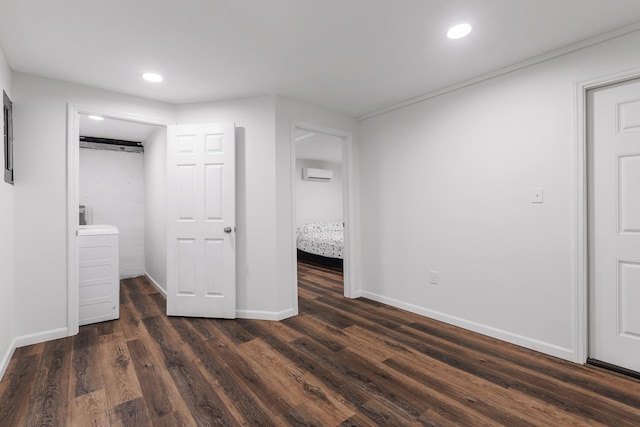 unfurnished bedroom with recessed lighting, dark wood finished floors, and a wall mounted air conditioner