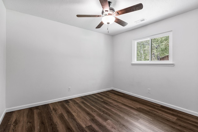 unfurnished room featuring a ceiling fan, baseboards, and dark wood-type flooring