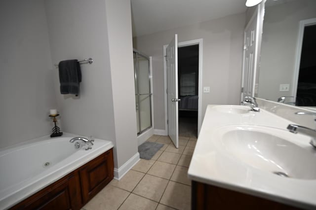 ensuite bathroom featuring ensuite bathroom, a sink, tile patterned floors, and a shower stall