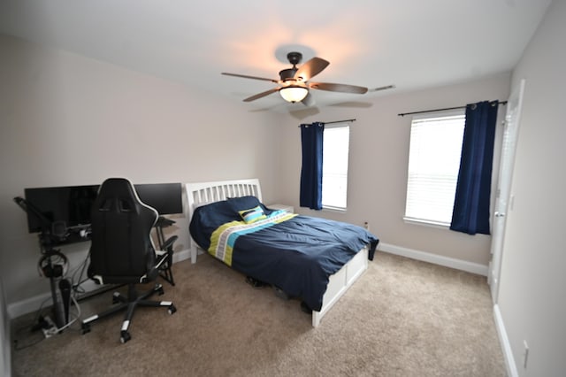 bedroom featuring baseboards, carpet, ceiling fan, and visible vents