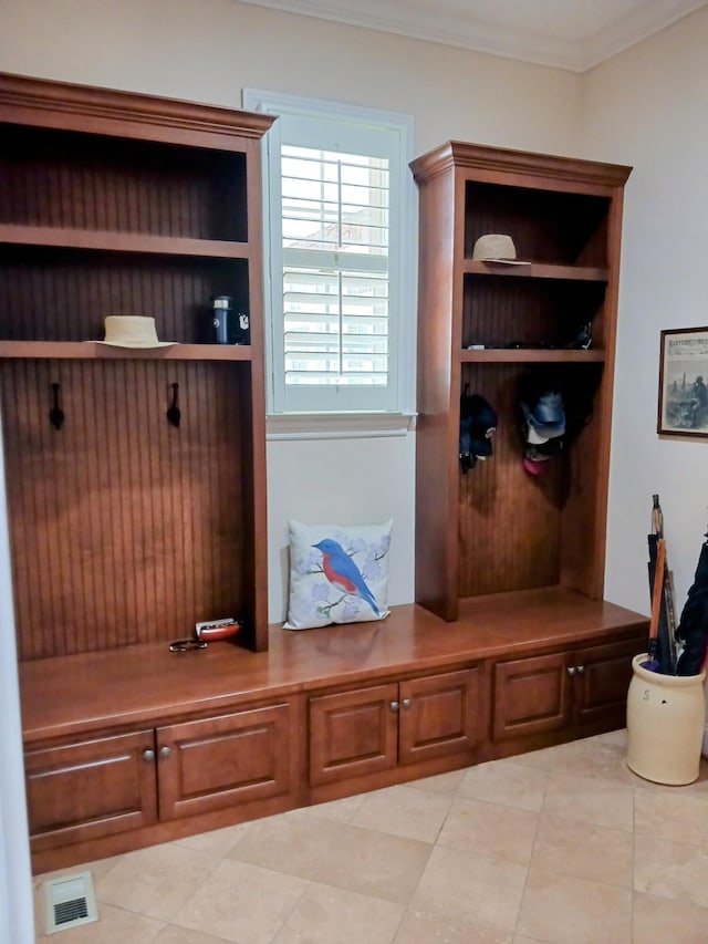 mudroom with visible vents, ornamental molding, and light tile patterned floors