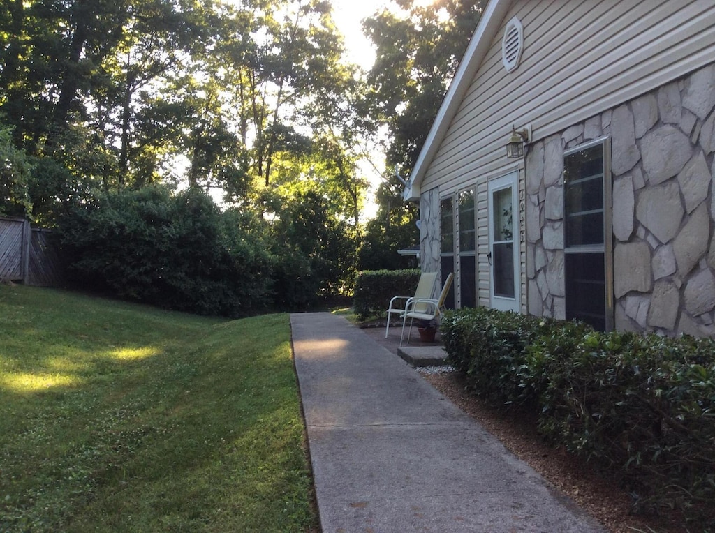 exterior space featuring a yard and stone siding