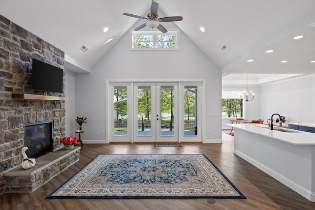 234 Reflection Dr, Dunlap, TN 37327 - living area with high vaulted ceiling, a fireplace, a chandelier, a ceiling fan, and baseboards