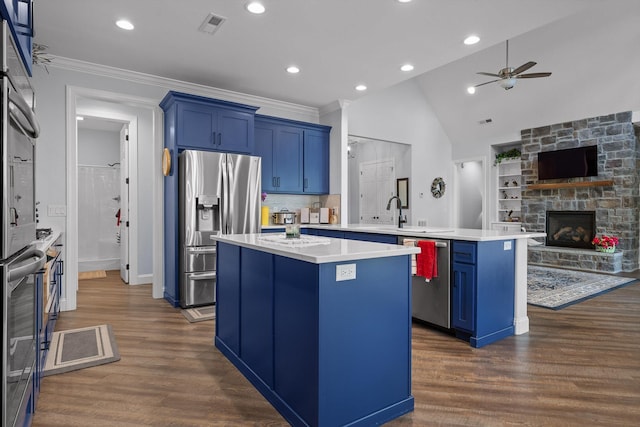 234 Reflection Dr, Dunlap, TN 37327 - kitchen featuring stainless steel appliances, blue cabinets, a center island, ceiling fan, and a peninsula