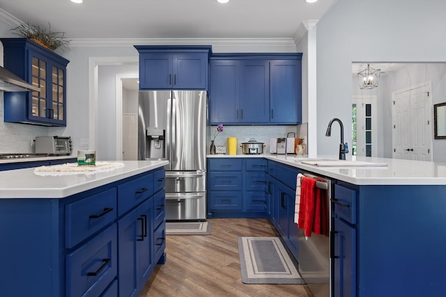 234 Reflection Dr, Dunlap, TN 37327 - kitchen with appliances with stainless steel finishes, a sink, blue cabinets, glass insert cabinets, and light wood-type flooring