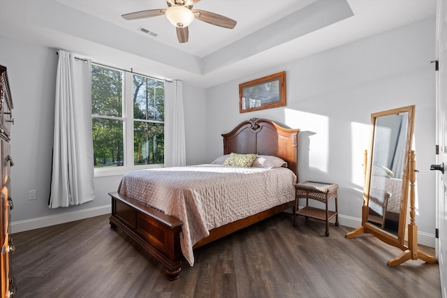 234 Reflection Dr, Dunlap, TN 37327 - bedroom featuring baseboards, a tray ceiling, dark wood-style flooring, and ceiling fan