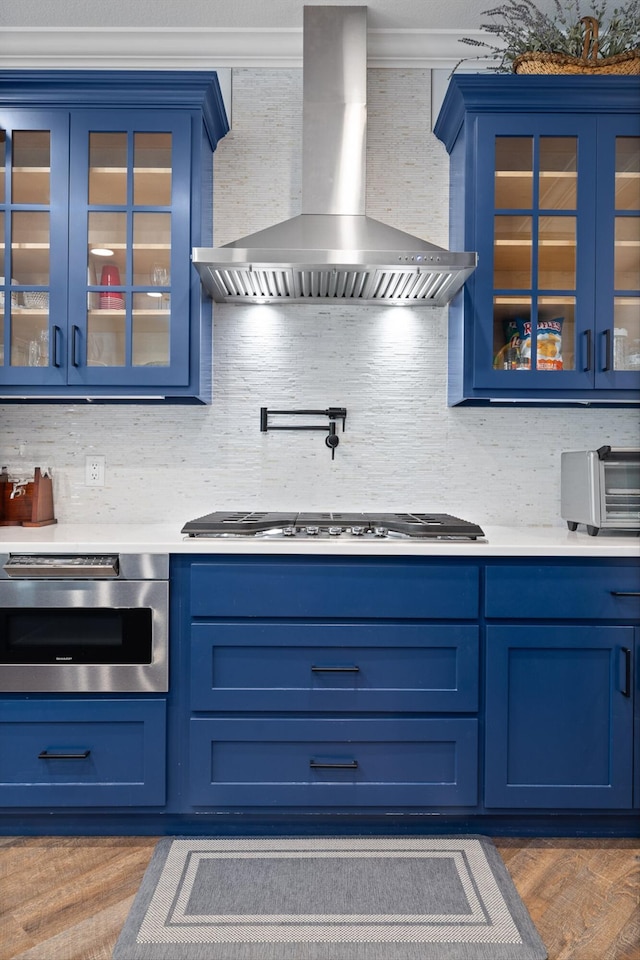 234 Reflection Dr, Dunlap, TN 37327 - kitchen with blue cabinets, wall chimney exhaust hood, and light countertops