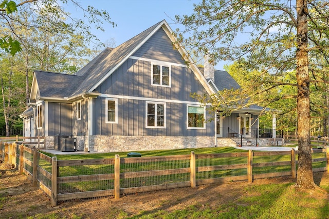 234 Reflection Dr, Dunlap, TN 37327 - view of front of property with a porch, a fenced front yard, stone siding, and board and batten siding