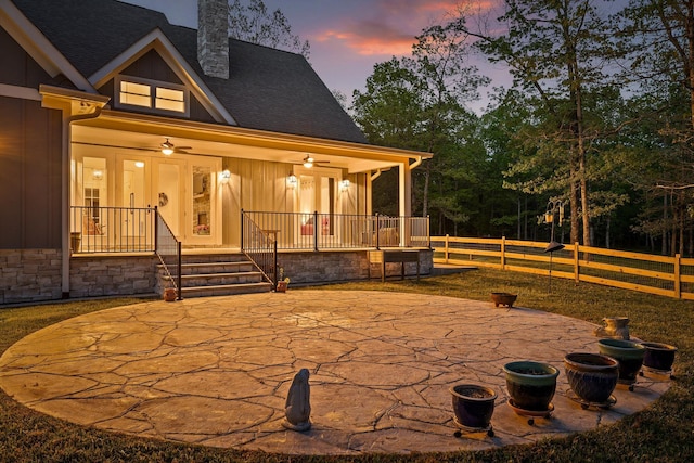 234 Reflection Dr, Dunlap, TN 37327 - back of property at dusk featuring a chimney, covered porch, fence, board and batten siding, and a shingled roof