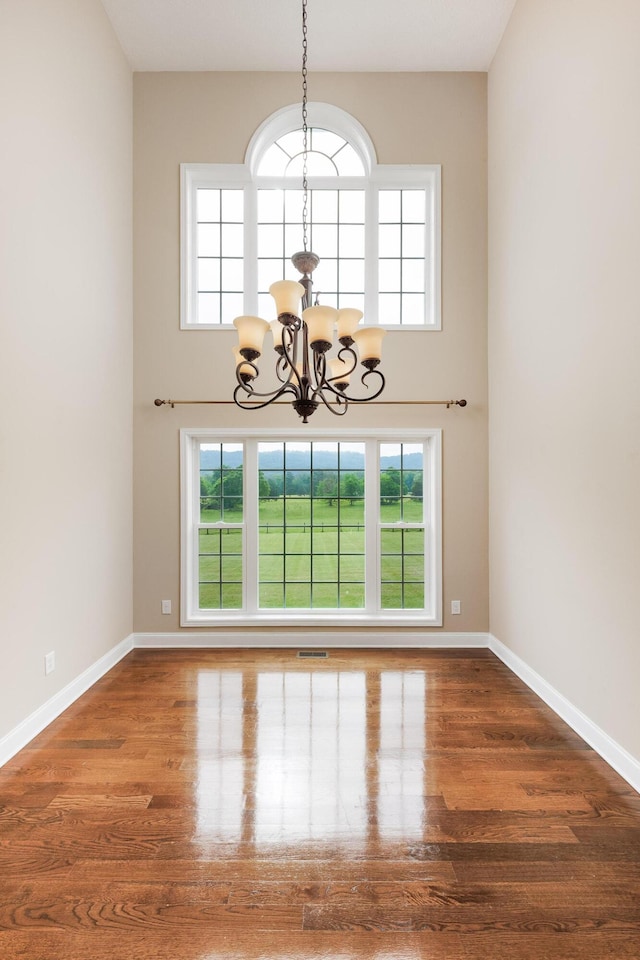 1594 Saunders Rd, Ringgold, GA 30736 - spare room featuring a chandelier, wood finished floors, baseboards, and plenty of natural light