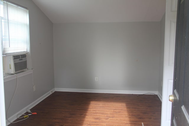 unfurnished room with wood-type flooring, baseboards, lofted ceiling, and cooling unit