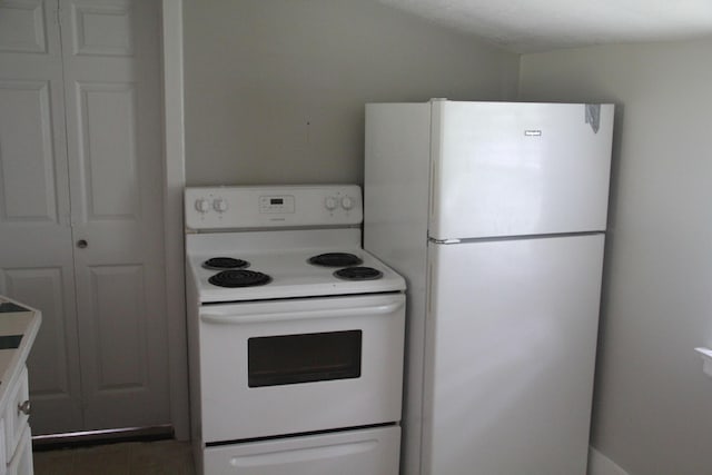 kitchen with light countertops and white appliances