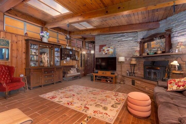 292 Hilltop Cir, Spring City, TN 37381 - living room with a wood stove, wood walls, wooden ceiling, wood finished floors, and beamed ceiling