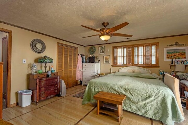 292 Hilltop Cir, Spring City, TN 37381 - bedroom with light wood-style floors, ornamental molding, a textured ceiling, and a closet