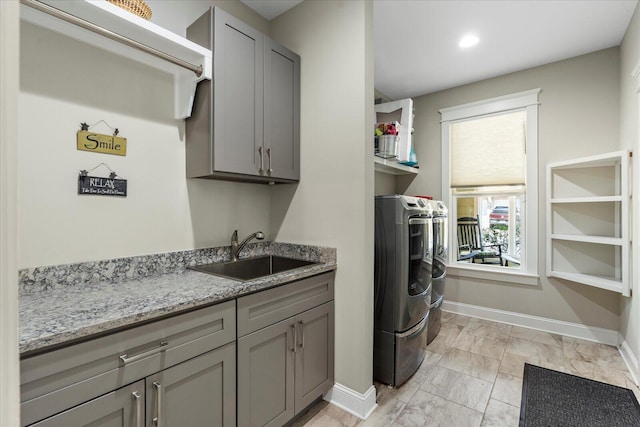 1383 Carrington Way, Chattanooga, TN 37405 - washroom featuring separate washer and dryer, cabinet space, baseboards, and a sink