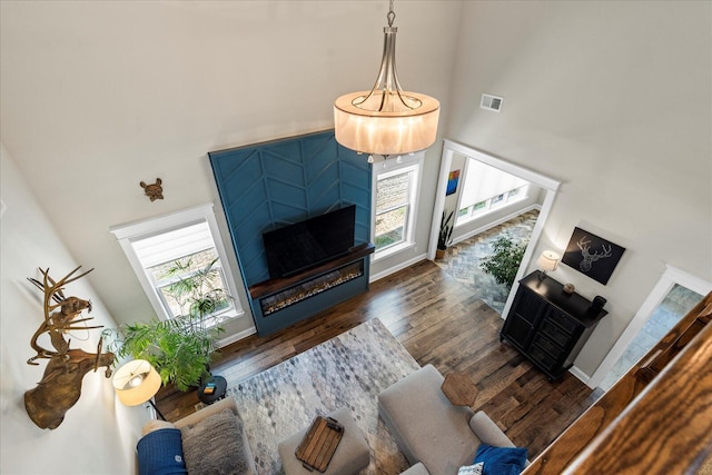 1383 Carrington Way, Chattanooga, TN 37405 - living area with wood finished floors, visible vents, baseboards, a towering ceiling, and a glass covered fireplace