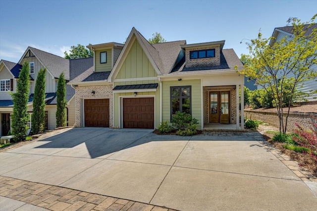 1383 Carrington Way, Chattanooga, TN 37405 - view of front of home featuring board and batten siding, driveway, brick siding, french doors, and a shingled roof