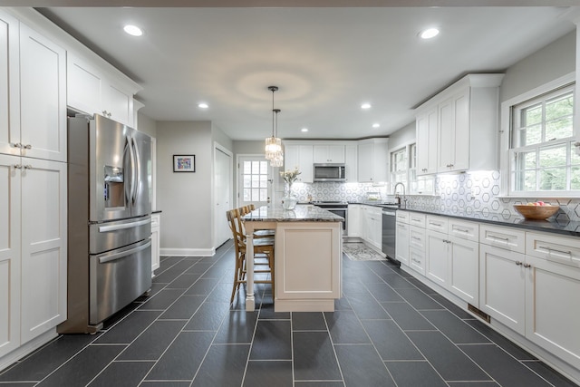 kitchen with white cabinetry, recessed lighting, tasteful backsplash, and appliances with stainless steel finishes