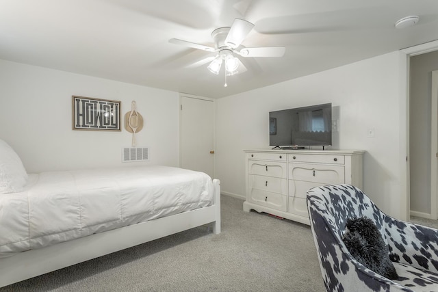 bedroom featuring a ceiling fan, baseboards, visible vents, and light colored carpet