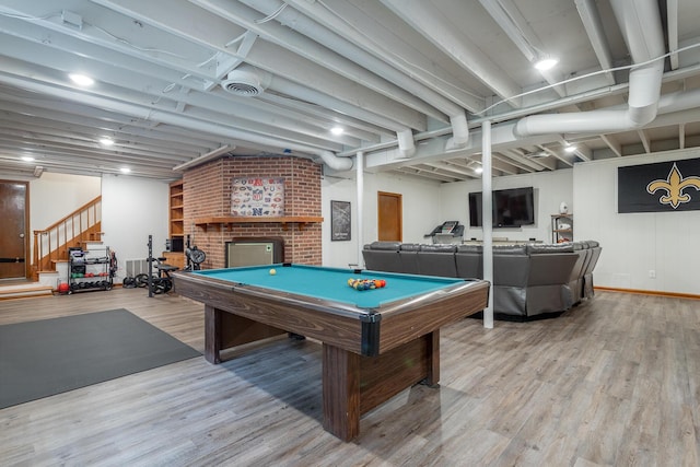 playroom with a brick fireplace, billiards, and wood finished floors