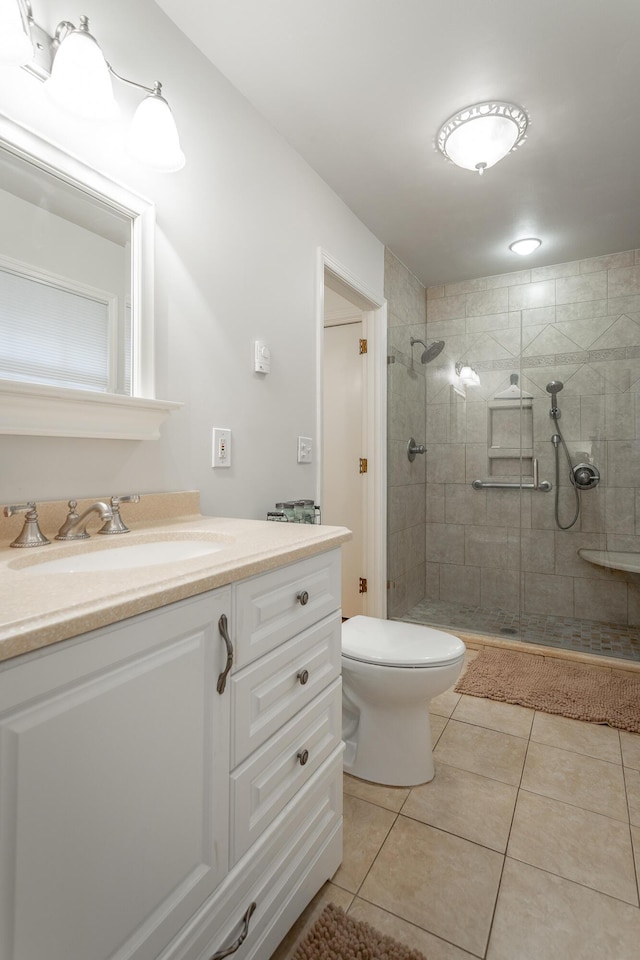 full bathroom with vanity, toilet, tile patterned flooring, and a shower stall