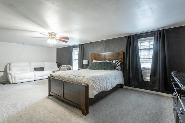 carpeted bedroom featuring ceiling fan and multiple windows