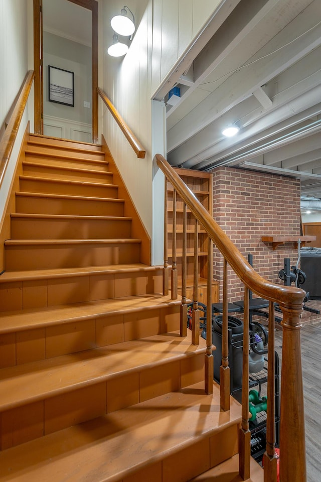 stairs featuring brick wall