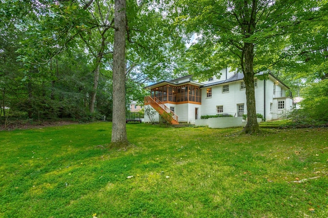 view of yard with stairs and a sunroom