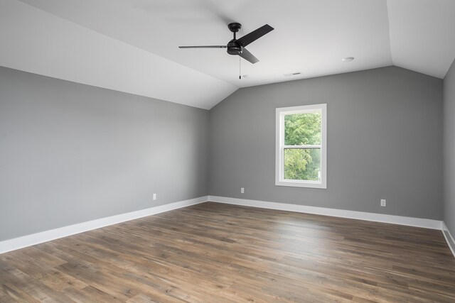 bonus room with baseboards, ceiling fan, vaulted ceiling, and dark wood-type flooring