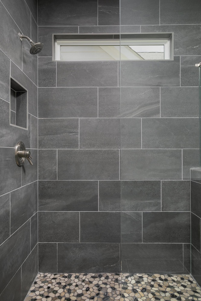 full bath featuring plenty of natural light and tiled shower