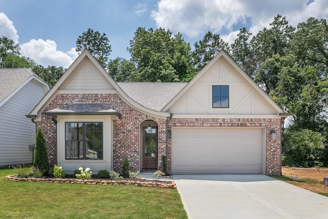 craftsman-style house with brick siding, a front lawn, roof with shingles, and concrete driveway
