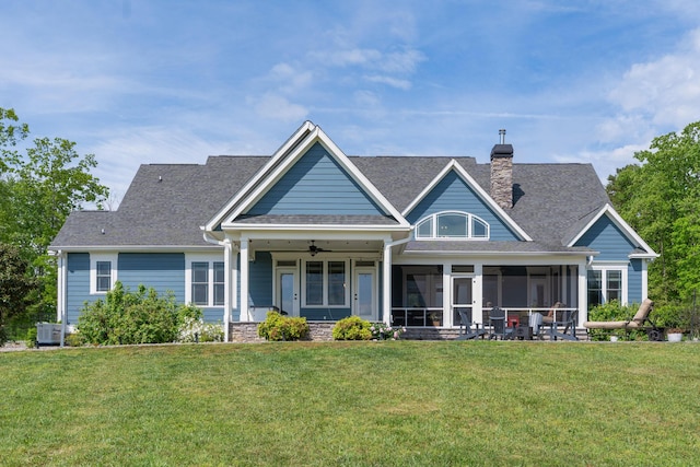 3086 Poe Rd, Soddy Daisy, TN 37379 - rear view of house featuring a yard, a sunroom, a ceiling fan, a chimney, and a shingled roof