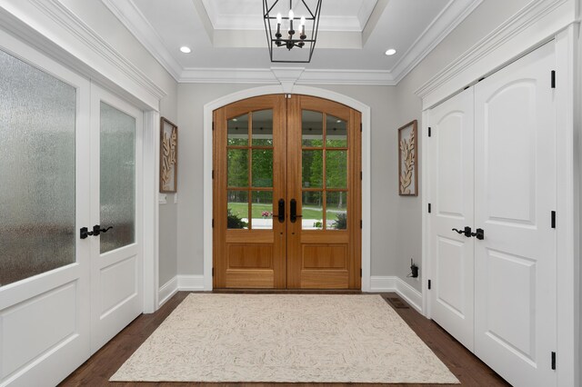 3086 Poe Rd, Soddy Daisy, TN 37379 - foyer entrance with french doors, dark wood-style floors, a chandelier, arched walkways, and crown molding
