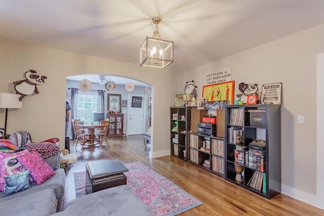 109 Sequoia Dr, Chattanooga, TN 37411 - living room featuring arched walkways, a chandelier, wood finished floors, and baseboards